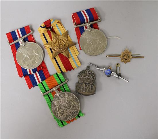 Four WW2 medals, three to the name on the box B.A. Ingram, a silver ARP badge, a silver RAF brooch and a 9ct gold brooch.